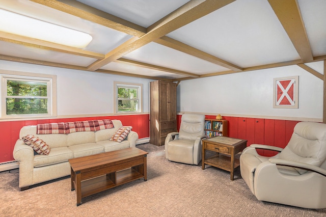 living room featuring beamed ceiling, baseboard heating, and light carpet