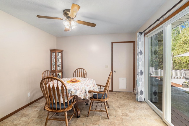 dining area with a baseboard radiator and ceiling fan