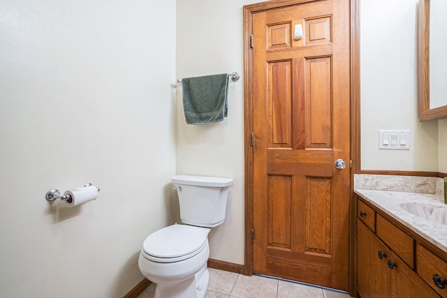 bathroom featuring tile patterned flooring, vanity, and toilet