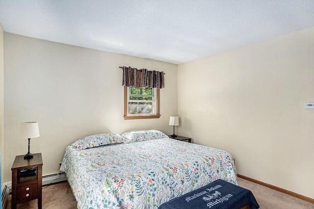 bedroom with carpet, a textured ceiling, and a baseboard radiator