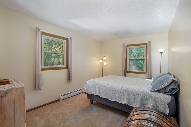 bedroom featuring a textured ceiling, carpet floors, a baseboard radiator, and multiple windows