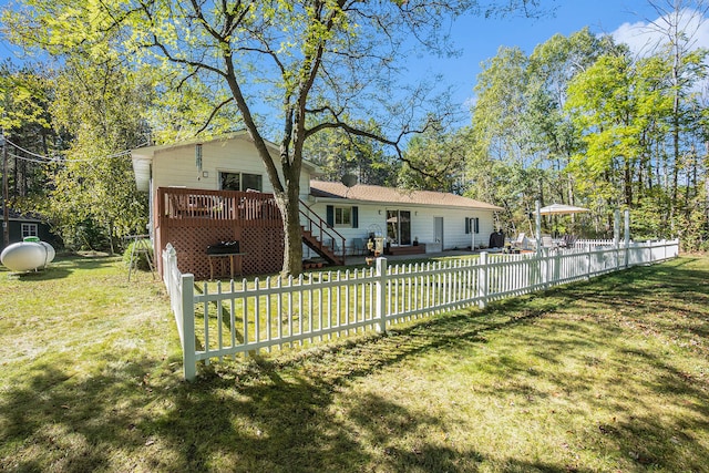 view of front of home with a front lawn and a deck