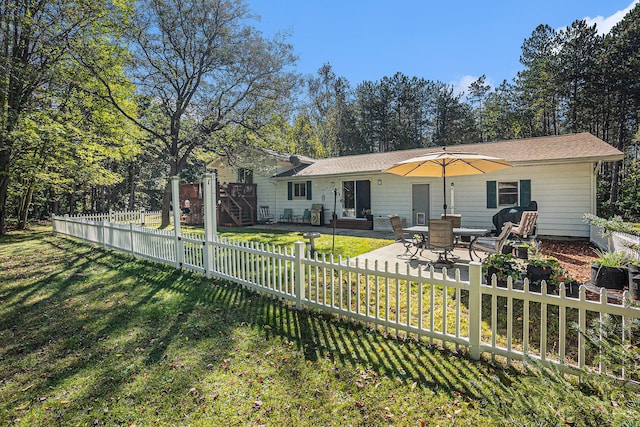 back of property featuring a yard and a patio