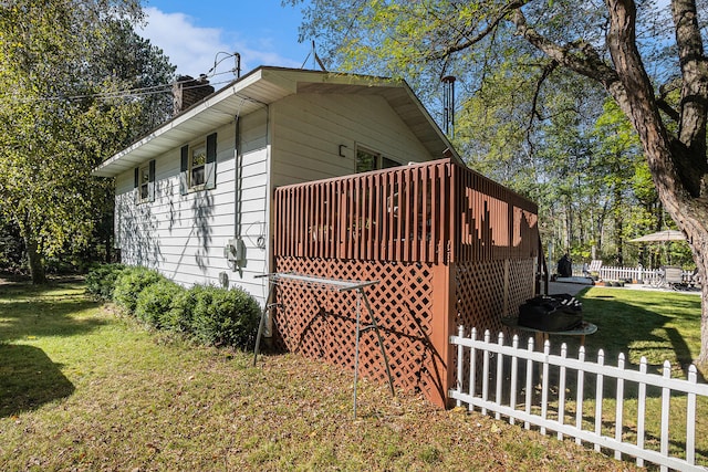 view of home's exterior featuring a yard and a deck