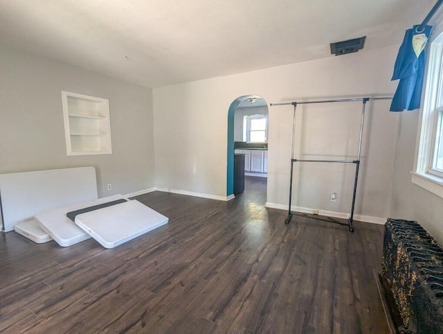 interior space featuring built in features and dark hardwood / wood-style floors