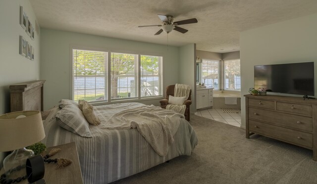7515 Bay Mdw, Canadian Lakes, MI 49346 - bedroom featuring multiple windows, light colored carpet, a textured ceiling, connected bathroom, and light tile patterned flooring