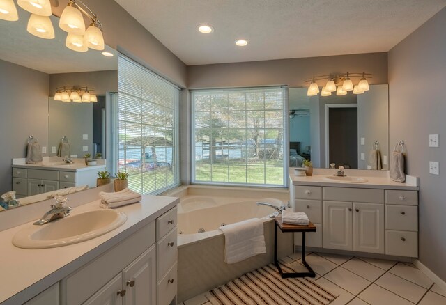 bathroom with tile patterned flooring, plenty of natural light, and vanity