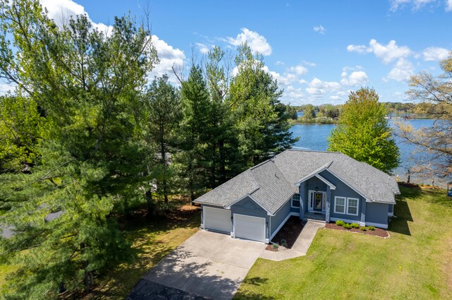 view of front facade featuring a water view, a front yard, and a garage