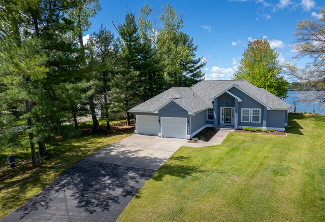 view of front of house featuring a front yard and a garage