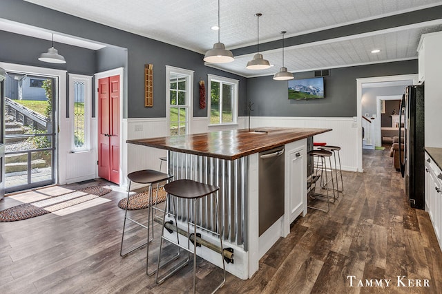 kitchen with white cabinets, dark wood-type flooring, decorative light fixtures, and wood counters