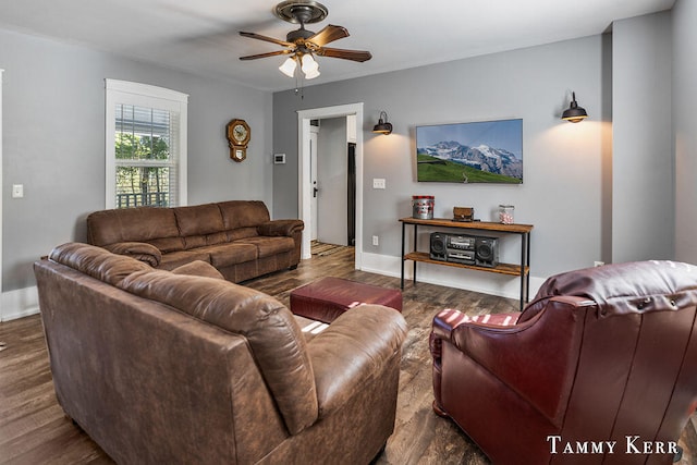 living room with ceiling fan and dark wood-type flooring