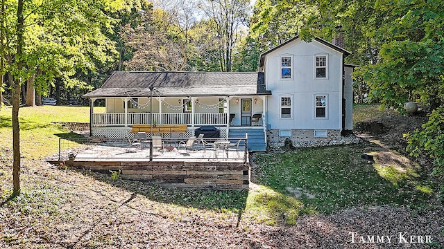 back of house featuring a lawn and a porch