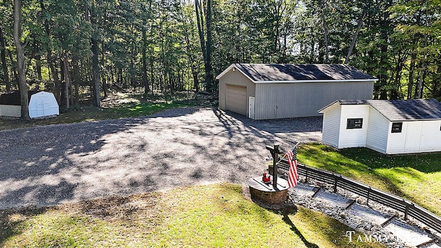 exterior space featuring an outbuilding, a yard, and a garage