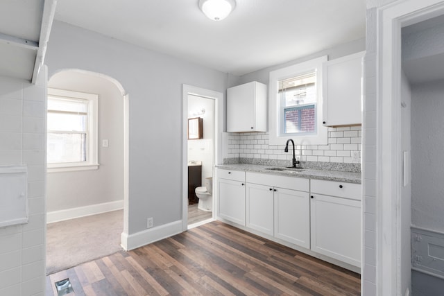 kitchen with white cabinetry, dark hardwood / wood-style flooring, and plenty of natural light