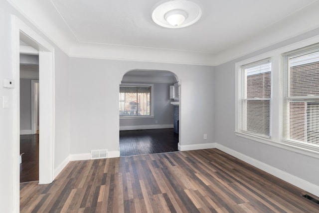 empty room with dark wood-type flooring