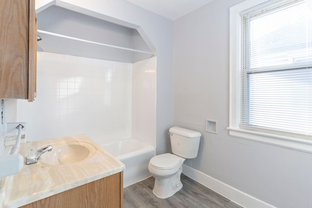 full bathroom with hardwood / wood-style floors, vanity, toilet, and shower / washtub combination