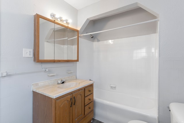 full bathroom featuring vanity, toilet, shower / bath combination, and tile walls