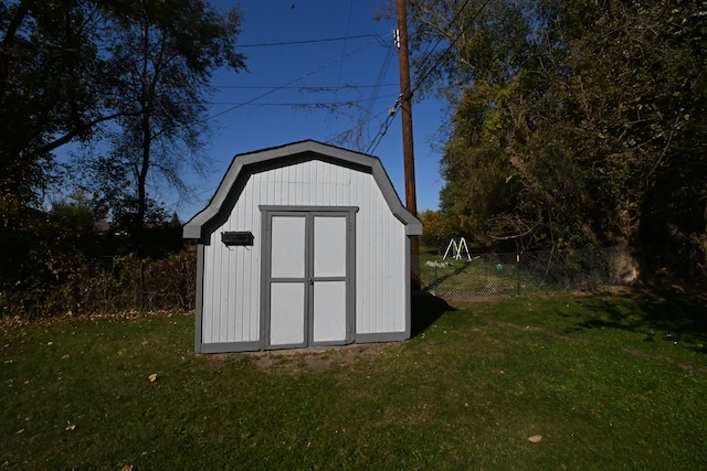 view of outbuilding with a lawn