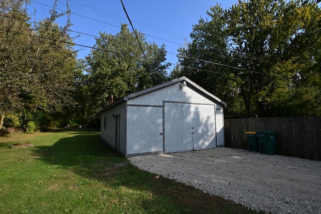 view of outbuilding featuring a lawn and a garage