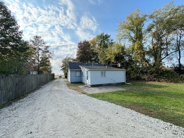 rear view of property featuring a lawn