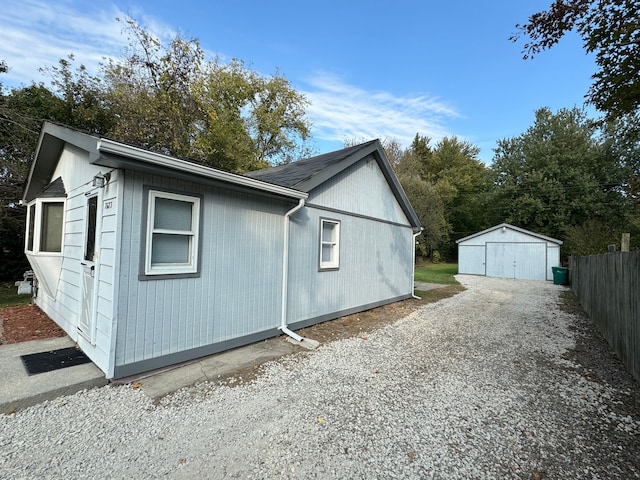 view of side of home featuring an outbuilding and a garage