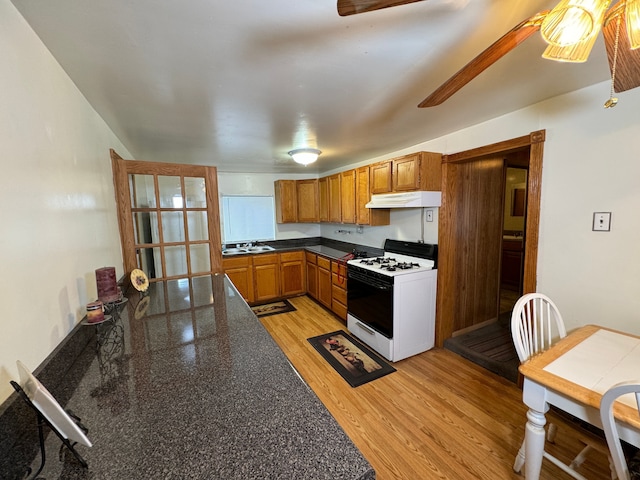 kitchen with ceiling fan, light hardwood / wood-style floors, white range with gas cooktop, and sink