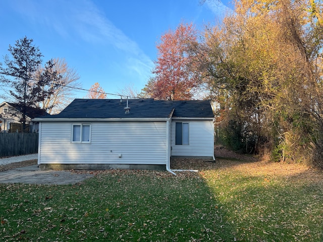 rear view of property featuring a yard