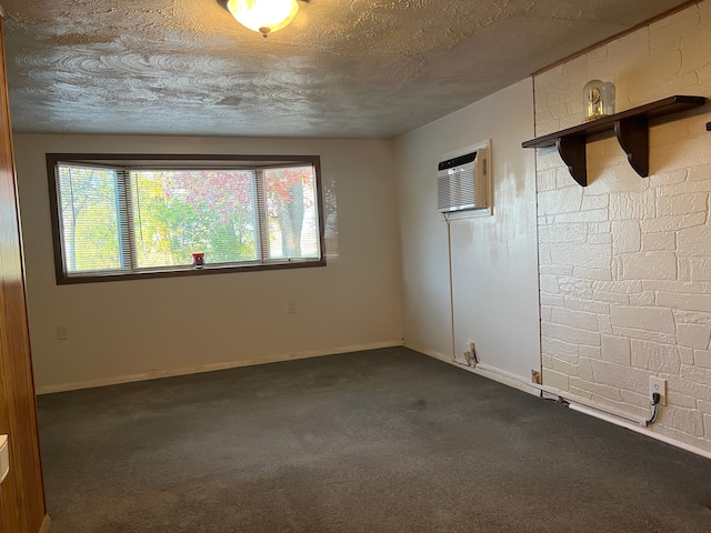 carpeted spare room with a wall mounted air conditioner and a textured ceiling