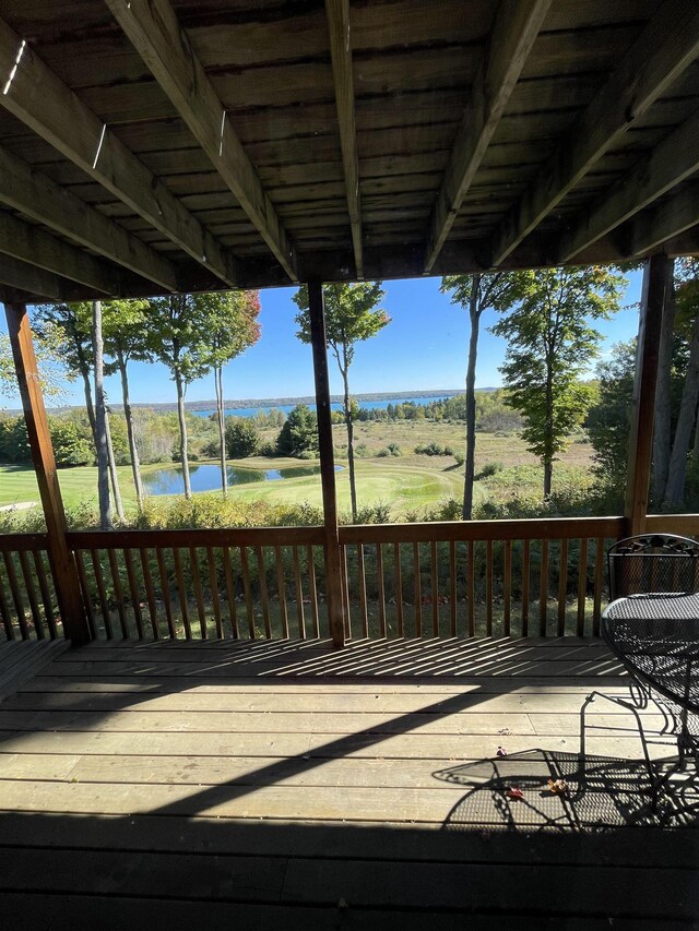 737 Maplewood Ln, Kewadin, MI 49648 - wooden deck with a water view