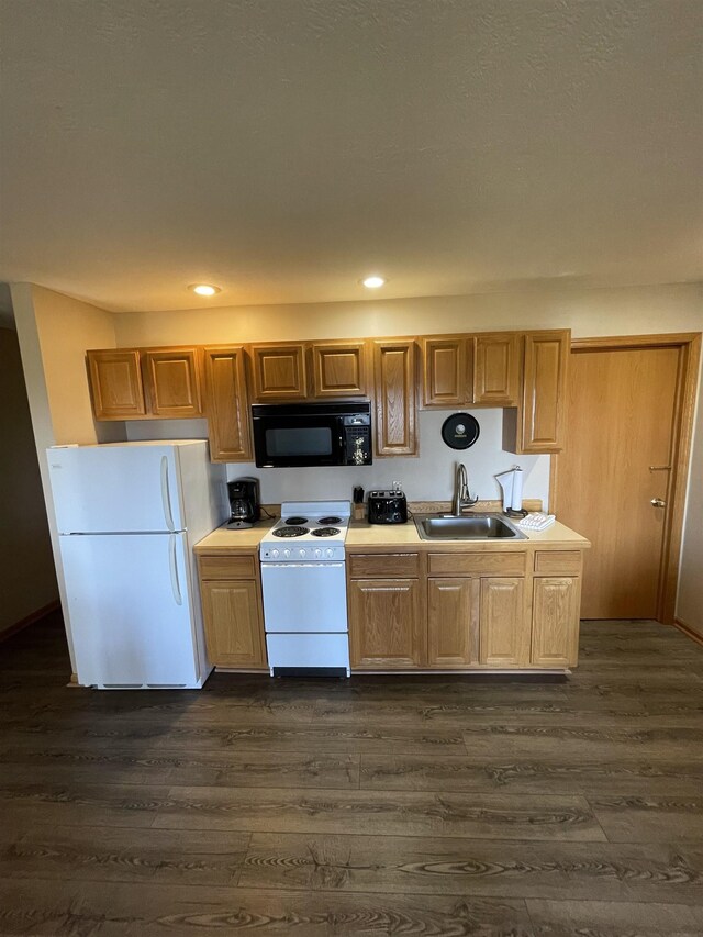 737 Maplewood Ln, Kewadin, MI 49648 - kitchen featuring white appliances, a sink, dark wood-style flooring, recessed lighting, and light countertops