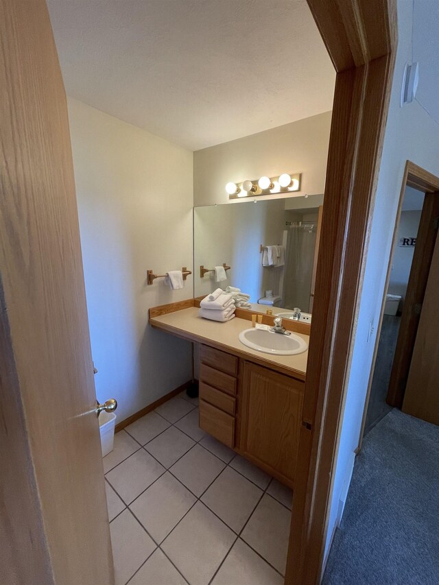 737 Maplewood Ln, Kewadin, MI 49648 - bathroom with vanity and tile patterned flooring