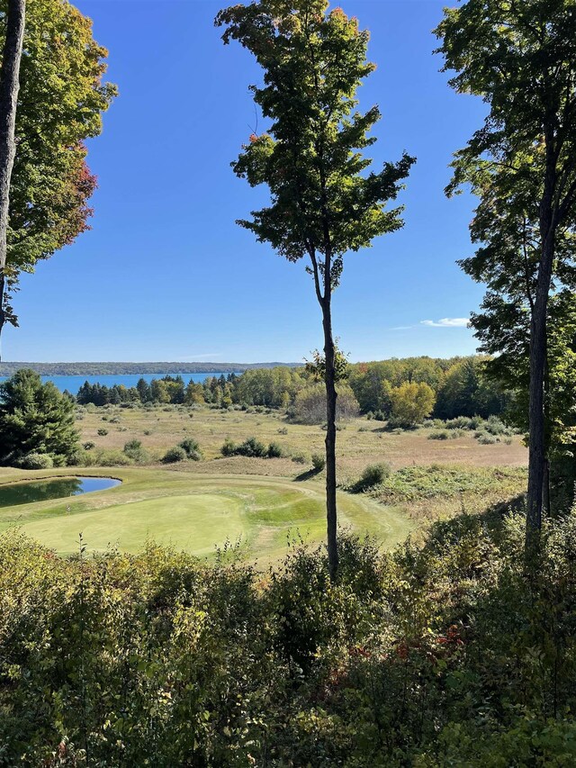 737 Maplewood Ln, Kewadin, MI 49648 - view of undeveloped land with a golf course and a large body of water
