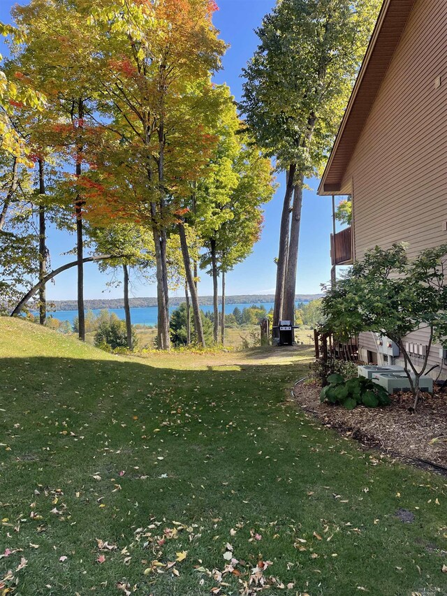 737 Maplewood Ln, Kewadin, MI 49648 - view of grassy yard with a water view