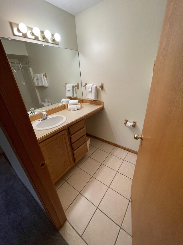 737 Maplewood Ln, Kewadin, MI 49648 - full bath featuring tile patterned flooring, vanity, and a shower with shower curtain