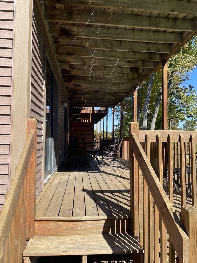 737 Maplewood Ln, Kewadin, MI 49648 - wooden deck featuring outdoor dining space