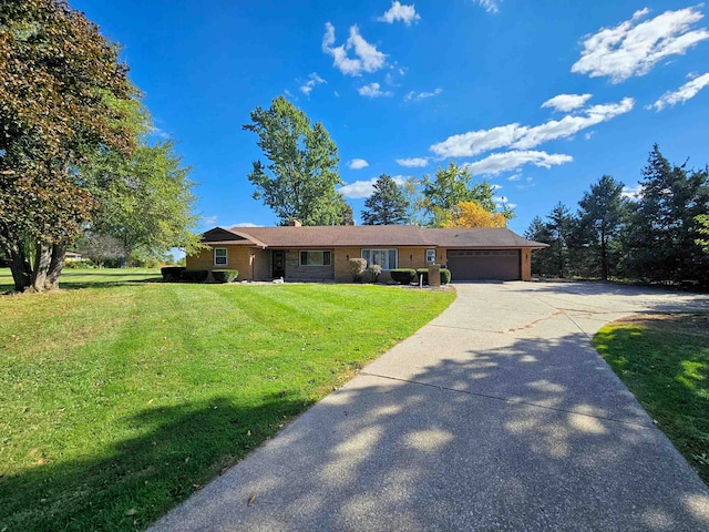 ranch-style house featuring a front yard and a garage