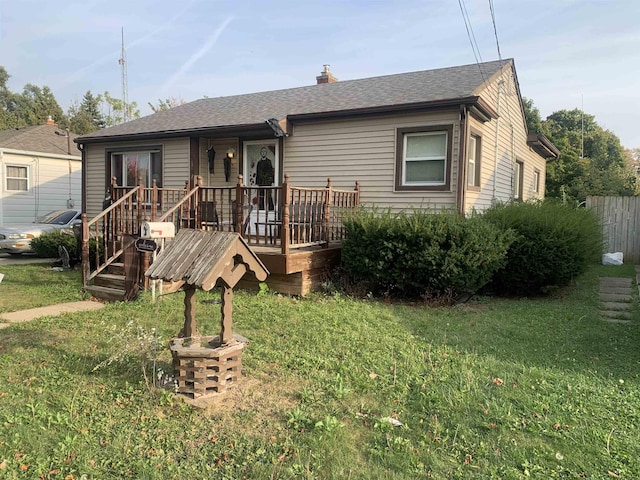 3019 Chicago Blvd, Flint, MI 48503 - view of front of property featuring a front yard, a deck, a chimney, and roof with shingles