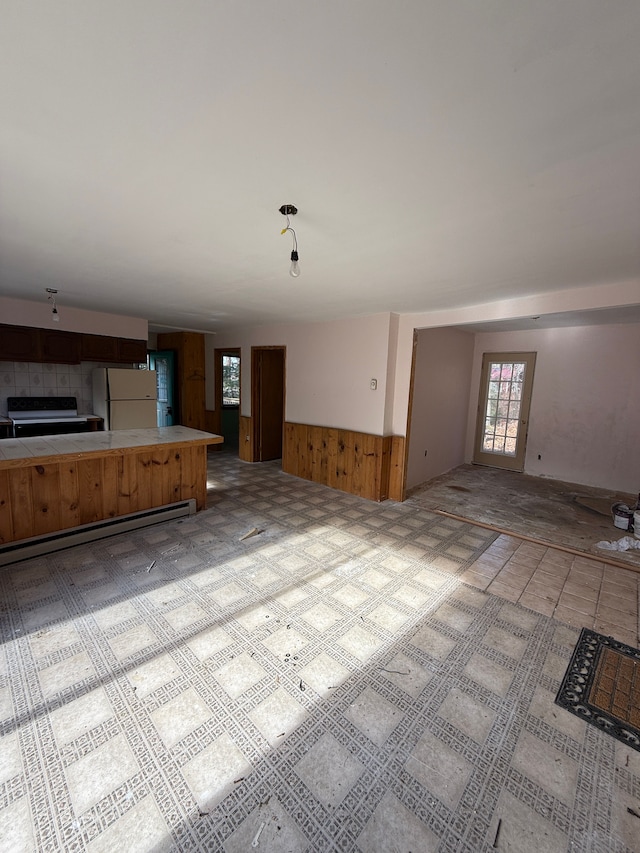 unfurnished living room with wooden walls