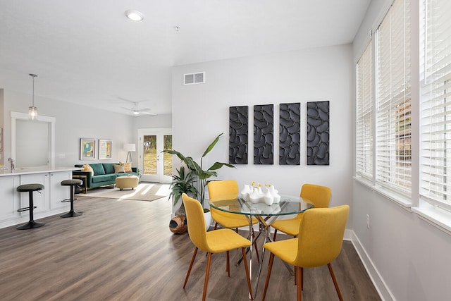 dining room with hardwood / wood-style flooring, ceiling fan, and a healthy amount of sunlight