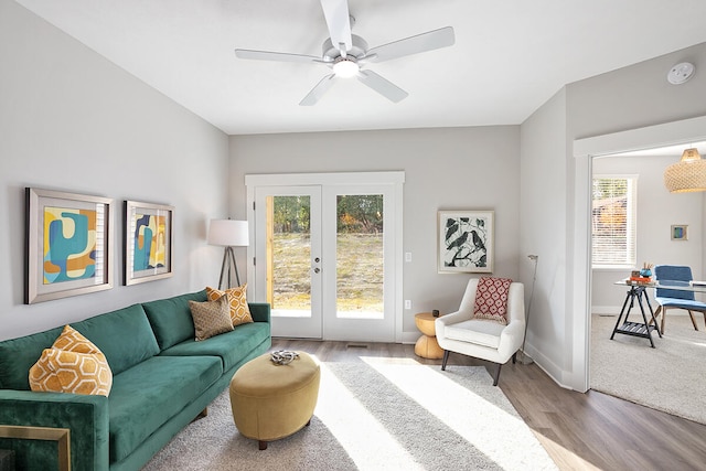 living room featuring ceiling fan, french doors, and wood-type flooring