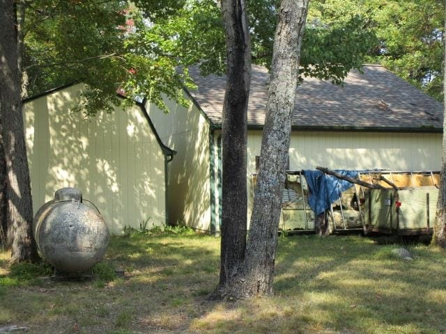 view of property exterior with a lawn