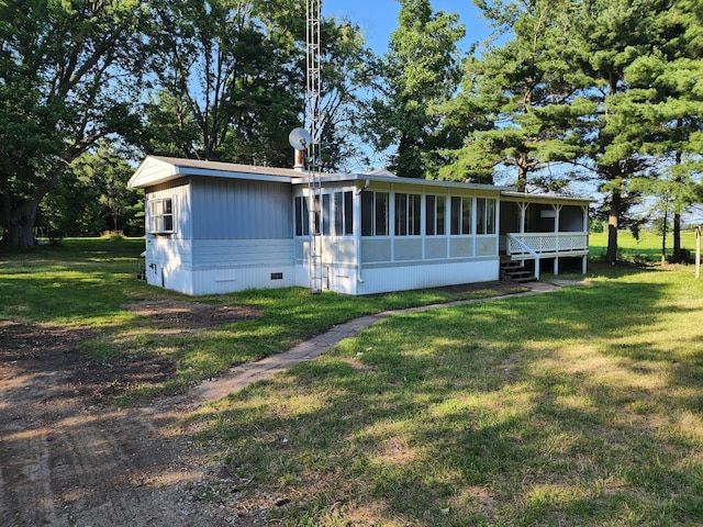 view of front facade with a sunroom and a front yard