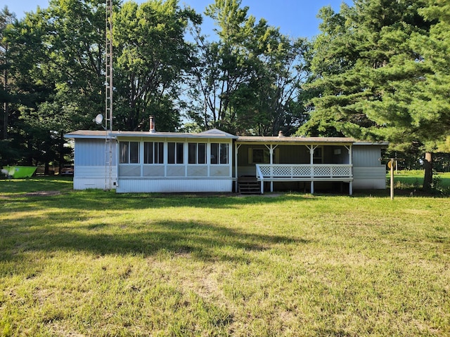 manufactured / mobile home featuring a front lawn and a sunroom