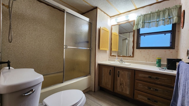 full bathroom with bath / shower combo with glass door, vanity, wood-type flooring, and toilet