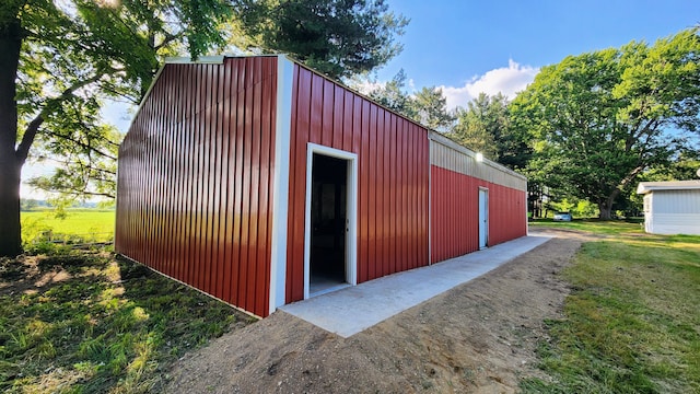 view of outbuilding featuring a yard