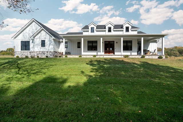 view of front facade featuring covered porch and a front yard