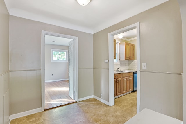 hall featuring ornamental molding and sink