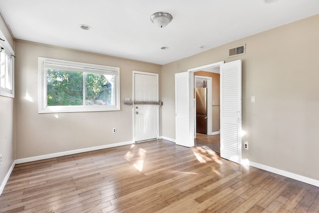 spare room with light hardwood / wood-style floors