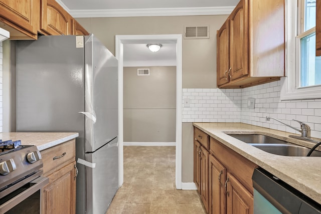 kitchen featuring backsplash, sink, stainless steel appliances, and ornamental molding