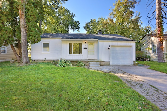 single story home featuring a garage and a front yard